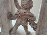 a statue of a man holding a baby in his arms