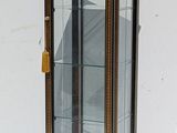 a small display case with a clock inside of it