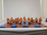 many figurines on a blue and orange chess board