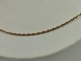 a close up of a gold chain on a mannequin