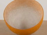 a yellow bowl sitting on top of a table