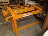 a yellow table with a sign on it in a warehouse