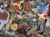 many different types of badges are scattered together on a table