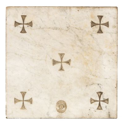 a white marble plaque with crosses and crosses on it