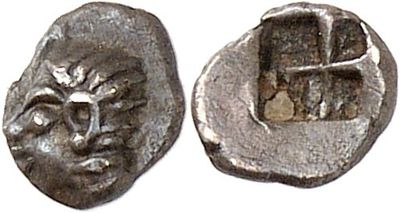 a close up of a coin with a face on it