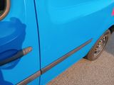 a blue van parked on the side of the road