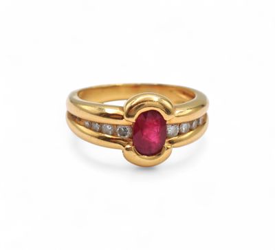 a gold ring with a ruby stone and diamonds