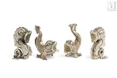 three silver figurines of birds and a fish on a white background