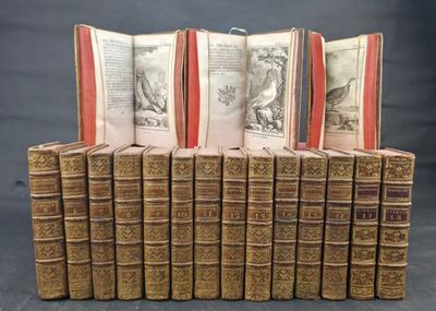 several old books are stacked on top of each other on a table