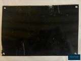 an old photo of a piece of black paper on a white surface