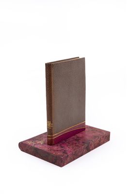 an image of a book on a wooden stand with a white background
