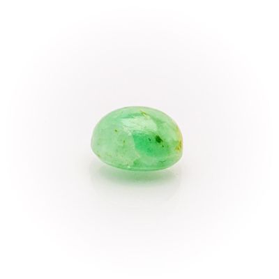 a close up of a green jade stone on a white surface