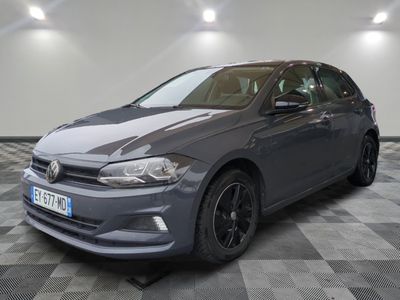 a grey volkswagen golf is parked in a room with a checkered floor