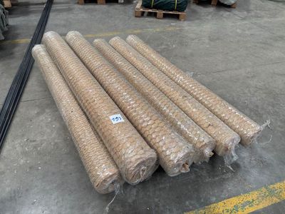 many rolls of plastic wrap on the floor in a warehouse