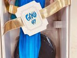 barbie doll in a box with a blue dress and gold accessories