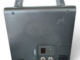 a black box with a button on it on a white surface