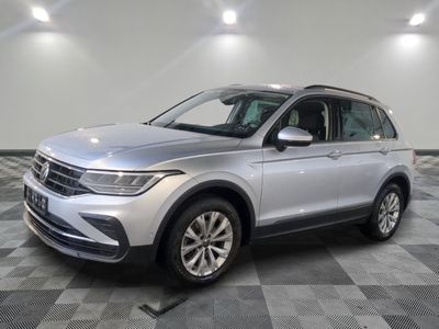 a silver volkswagen suv parked on a checkered tile floor