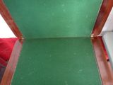 a small open suitcase sitting on a red chair