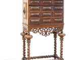 a small wooden cabinet with drawers on a stand