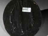 a black plate with a label on it sitting on a table