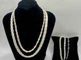 a close up of a necklace and bracelet on a mannequin