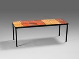 a table with a colorful tile top and metal legs
