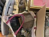 a bag full of shoes and a pair of shoes next to a picture frame