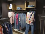 a lot of clothes that are on display in a store