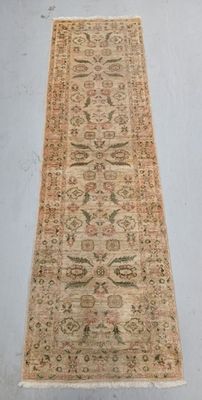 an antique rug with a long, narrow design on a white floor
