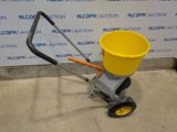 a yellow bucket sitting on the side of a cart