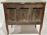 a wooden table with a marble top and two legs