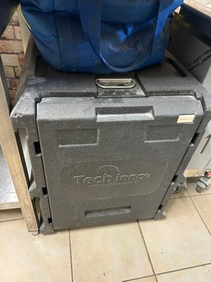 a large blue bag sitting on top of a cooler