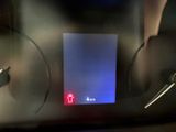 a picture of a car dashboard with a blue light