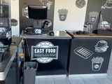 an image of a fast food restaurant with chalk drawings on the wall