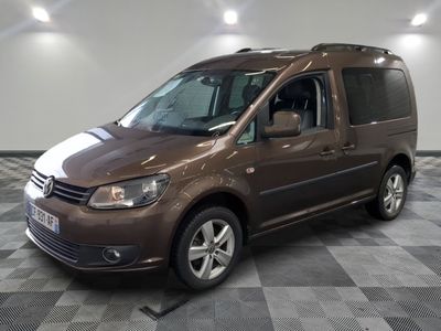 the brown van is parked on a checkered floor in the garage