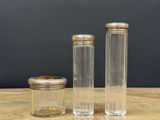 three clear glass jars with wooden lids sitting on a wooden table
