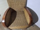 a wicker chair sitting in a corner of a room