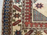 an old rug with a blue and red design on a white background