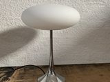 an image of a white table lamp sitting on top of a wooden floor