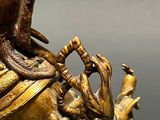 a bronze statue of a man with a snake on his arm