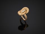 a gold and diamond ring, by person