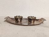 pair of silver plated candlesticks on a leaf shaped tray