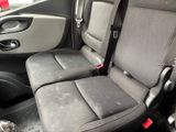 two seats in the back of a car that are dirty