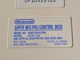 a nintendo super nes pad control deck on display