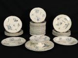 several plates and bowls sitting on top of each other on a black surface