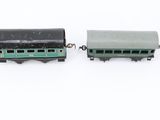 four toy trains sitting next to each other on a white surface