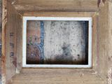 an old picture of a picture frame with a brick wall in the background