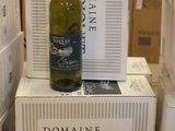 a bottle of wine sitting on top of a stack of boxes
