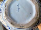a blue and white vase sitting on a table
