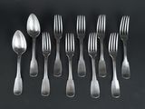 six forks and spoons are arranged in a row on a black surface